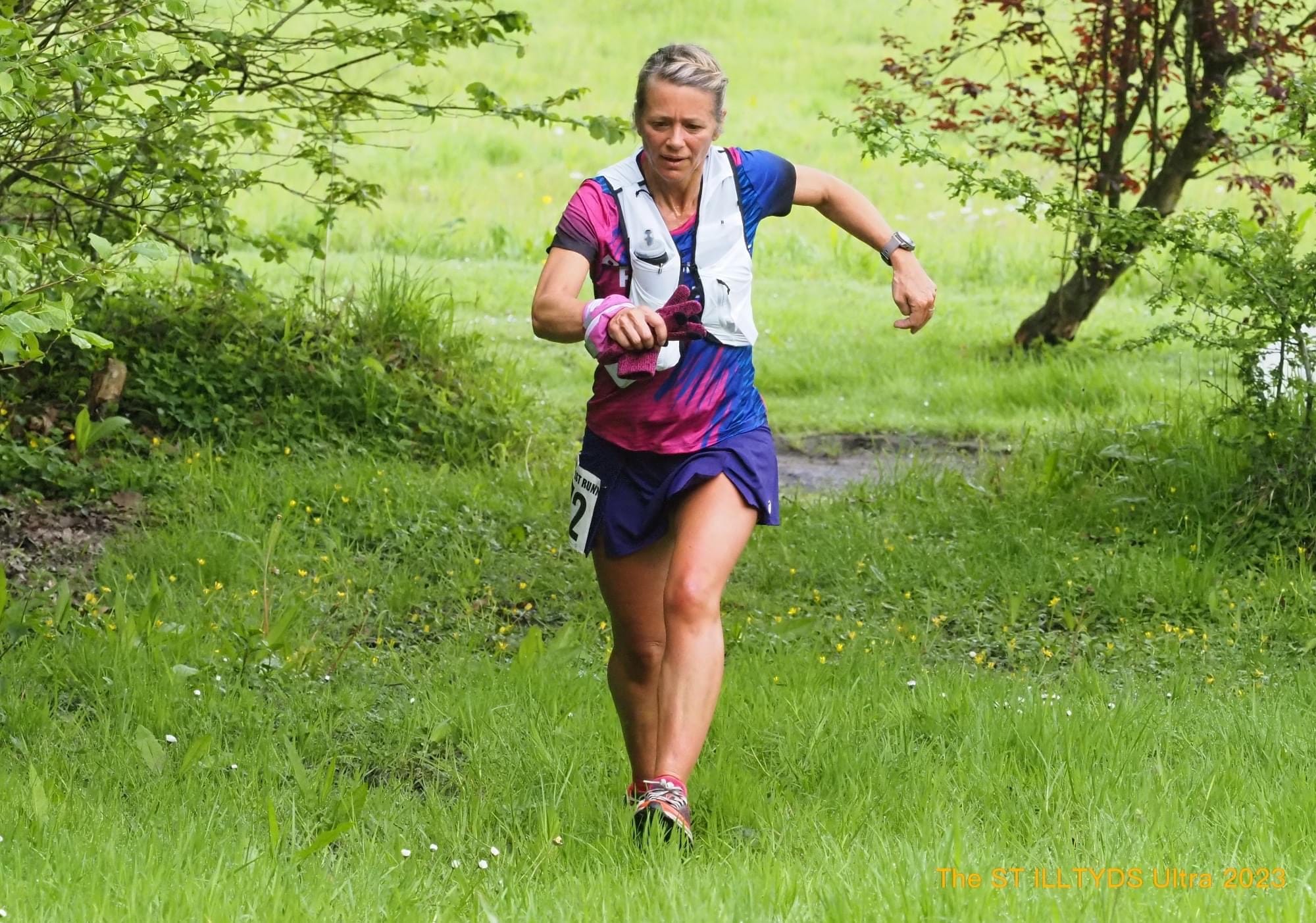 Chelle White running on a woodland trail